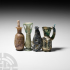 Roman Glass Vessel Collection. c.2nd century B.C.-4th century A.D. A group of four Hellenistic and Roman glass perfume, toilet and other vessels compr...