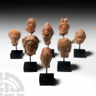 Roman Terracotta Head Collection. 1st century B.C.-2nd century A.D. A group of votive terracotta figure heads comprising: a head of a priest wearing a...