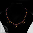Roman Gold and Amethyst Necklace. 1st-2nd century A.D. A restrung necklace composed of biconical amethyst beads of graduated size interspersed with sm...