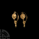 Roman Gold Filigree Earring Pair. 1st century B.C.-3rd century A.D. A matched pair of Hellenistic or Roman gold hoop earrings, each composed of a hoop...