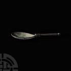 Roman Silver 'Travel' Spoon. 4th century A.D. A short silver spoon with shallow piriform bowl, raised neck with movable pinned hinge attached to the s...
