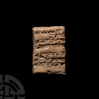 Mesopotamian Cuneiform Tablet. 3rd-2nd millennium B.C. A ceramic cuneiform tablet with a slightly curved profile, cuneiform text to both faces. 81 gra...