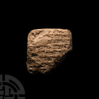Ur III Dynasty Cuneiform Tablet. 22nd to 21st century B.C. A roughly pillow-shaped ceramic cuneiform tablet, bearing clear cuneiform script to both fa...