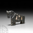 Ghaznavid Inlaid Stone Figurative Horse. 12th-13th century A.D. A bifacial figurative horse carved from serpentine, punched ring-and-dot detailing to ...