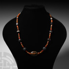 Carnelian and Agate Bead Necklace. Mainly 1st millennium B.C. A restrung necklace composed of graduated carnelian and banded agate beads of mainly sph...