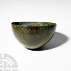 Luristan Bowl with Engraved Design. 13th-6th century B.C. A roughly hemispherical bronze bowl decorated with three circumferential engraved bands to t...