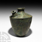 Very Large Western Asiatic Brewing Still. 8th-10th century A.D. or Earlier. A bronze brewing still or pouring vessel with carinated body, short neck, ...