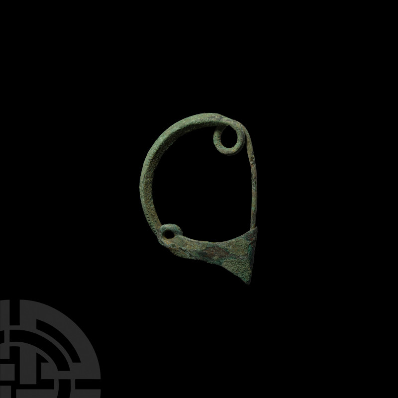 Large Greek Bow Brooch. 5th century B.C. A large bow brooch with integral coil a...