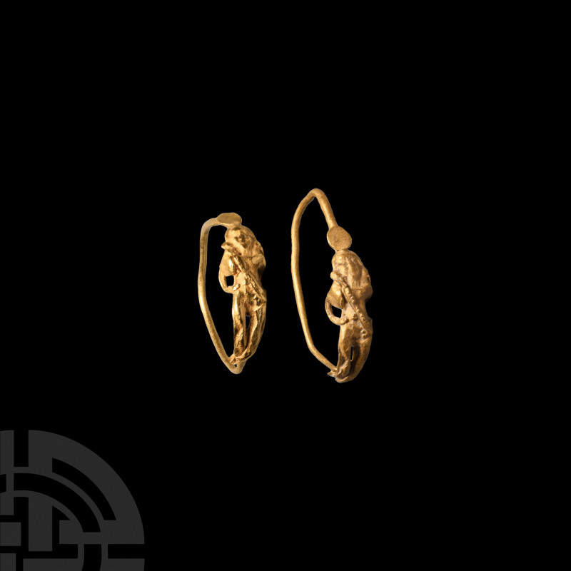 Hellenistic Gold Eros Earring. 2nd-1st century B.C. A gold earring with a wire h...