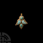Gold Lotus Flower Pendant with Turquoise. c.1st century A.D. A gold pendant formed as a lotus flower, four raised cells to the body set with turquoise...