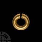 Achaemenid Gold Hair Ring. c.5th century B.C. A hollow-formed sheet gold penannular hair ornament with crimped circumferential band above each end. 11...