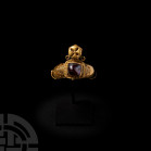 Gold Ring with Cabochon and Cross Pyxis. 8th-10th century A.D. A gold ring composed of a tapering D-section hoop and rectangular bezel, cruciform pyxi...