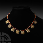 Elamite Carnelian Bead Necklace with Gilt Silver Pendants. 2nd millennium B.C. A restrung designer necklace composed of elongated carnelian and short ...