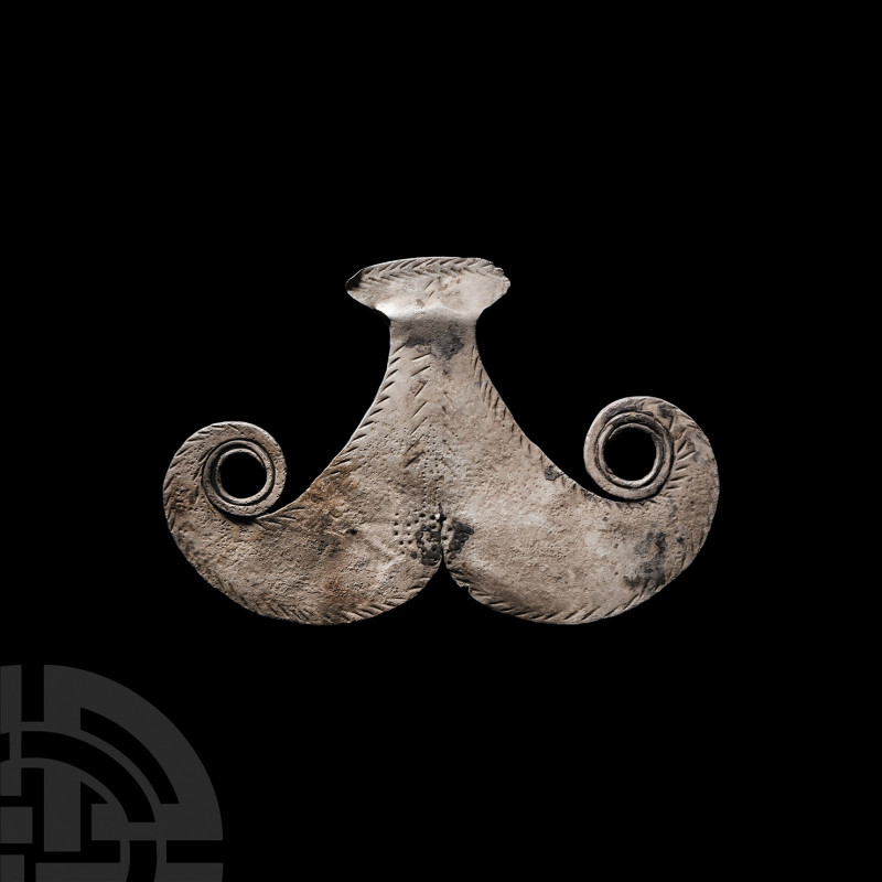 Elamite Silver Female Idol Pendant. 4th-3rd millennium B.C. A silver idol compos...