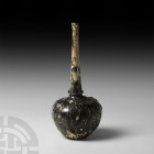 Honeycomb Vessel. 10th-12th century A.D. A glass bottle with globular body, broad shoulder, tapering cylindrical neck and pontil to base, applied trai...