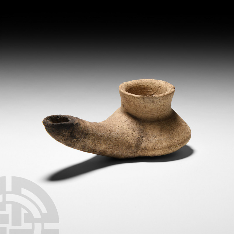 Parthian Oil Lamp. 2nd-3rd century A.D. An unglazed terracotta lamp, the sphero-...