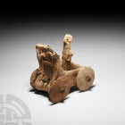 Mesopotamian Idol in Carriage. 4th-3rd millennium B.C. A ceramic idol standing in a carriage or wagon, raised stylised animals in relief to the outer ...