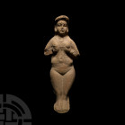 Elamite Goddess or Fertility Idol. 3rd-2nd millennium B.C. A ceramic fertility idol modelled in the half-round as a naked female figure cupping her br...
