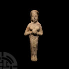 Elamite Goddess or Fertility Idol. 3rd-2nd millennium B.C. A ceramic fertility goddess idol modelled in the half-round with hands clasped together bet...