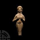 Elamite Goddess or Fertility Idol. 3rd-2nd millennium B.C. A ceramic fertility goddess idol produced in the half-round as a nude female figure claspin...