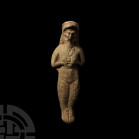 Elamite Goddess or Fertility Idol. 3rd-2nd millennium B.C. A ceramic fertility goddess figure modelled in the half-round with hands clasping breasts, ...