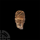 Roman Bone Pin Finial. 1st-3rd century A.D. A carved bone figure head in the form of an elderly woman with large eyes, slender nose, small, sunken mou...