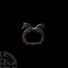 Late Roman Zoomorphic Buckle Loop. 4th-5th century A.D. A bronze buckle loop with tremolier hatching to the shoulders (opposed dolphins?) and two addo...