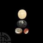 Roman and Other Gemstone Intaglio Collection. 1st century A.D. and later. A mixed group of four oval-shaped intaglio gemstones comprising: a banded ca...