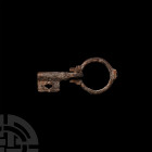 Roman Military Key Ring. c.4th-5th century A.D. A bronze folding military key ring composed of a hoop and free-moving bit. 9.2 grams, 51 mm (2 in.) Az...