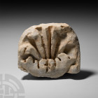 Roman Marble Monument Section. 2nd-3rd century A.D. A marble statue or antefix formed as an ellipsoid panel and triangular-section stub to the reverse...