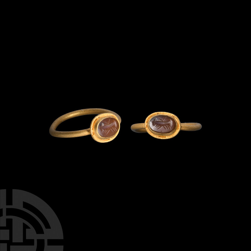 Roman Clasped Hands Gemstone in Gold Ring. 2nd-3rd century A.D. A gold ring with...