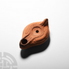 Roman Terracotta Oil Lamp. 4th-5th century A.D. A terracotta oil lamp with carinated body, integral lug handle, plain incised panels to the shoulders ...