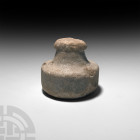 Roman Marble Grinding Stone. c.2nd century B.C.-2nd century A.D. A carved marble grinding stone or pestle composed of a squat discoid body and taperin...