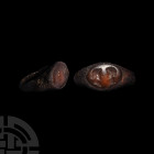 Roman Iron Ring with Facing Busts Gemstone. 1st-3rd century A.D. An iron finger ring composed of round-section hoop expanding at the arms to an oval b...