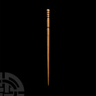 Roman Bone Pin. 2nd-3rd century A.D. A hair pin made of bone with cylindrical shaft, twisted head and plain body with three grooves, tapering to a sha...