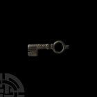 Large Roman Door Key. 3rd-4th century A.D. A bronze door key with collars towards the circular bow, rectangular bit. 55.6 grams, 82 mm (3 1/4 in.) Ger...