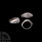 Roman Silver Ring Inscribed with C.UL.R. 3rd century A.D. A silver ring with ellipsoid double-concave hoop, expanding towards the conical shoulders, o...