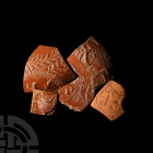 Roman 'Thames' Redware Fragment Group. 1st-3rd century A.D. A group of five redware fragments comprising various sizes and designs: an urn-shaped twin...