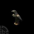 Roman Eagle Statuette. 1st-2nd century A.D. A bronze statuette modelled in the round as an eagle standing on a sub-hexagonal base, wings part-spread, ...