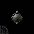Roman Enamelled Umbonate Brooch. 2nd century A.D. An umbonate brooch with four lugs to the circumference, one pierced, central dome with stamped trian...