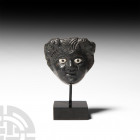 Roman Actor's Mask Mount. 1st-2nd century A.D. A bronze mount of an actor's mask depicting a satyr with rounded features, copious hair, two small club...