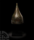 Urartian Helmet with Snakes. 8th-7th century B.C. A broad conical bronze helmet, hammered from a single metal sheet, the front with a raised abstract ...
