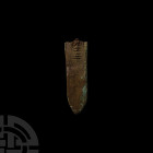 Roman Legionary Strap End. 4th-5th century A.D. A tongue-shaped bronze strap end tip, one side with remains of an inscription, the end with remains of...