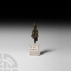 Roman Priapus Statuette. 1st-3rd century A.D. A bronze Priapus figure modelled standing with detailing to face, beard and hair, hands held in front of...