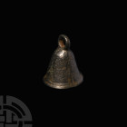 Roman Bronze Bell. 1st-4th century A.D. A bronze bell with tapering round-section body and flared base, integral suspension loop. 75 grams, 50 mm (2 i...