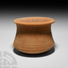 Roman Terracotta Pot. 2nd-4th century A.D. A carinated terracotta pot with chamfered rim and circumferential grooves to lower body. 720 grams, 15.2 cm...