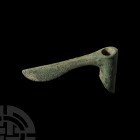Luristan Sar-e Tabar Socketted Axehead. 2nd millennium B.C. A bronze axe with plain cylindrical socket and staff, off-set at the base, of simple undec...