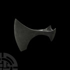 Viking Age Broad Axehead. 10th-11th century A.D. An iron bearded axehead with broad flaring triangular-section blade and chin to the lower edge, round...
