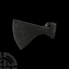 Viking Age Broad Axehead. 9th-12th century A.D. A hand-forged iron axehead with triangular-section blade widening to a broad bevelled edge with curved...