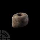Danish Stone Battle Axe. Late 4th millennium B.C. A black diorite axe head with central circular socket for attachment to an organic shaft, old inked ...